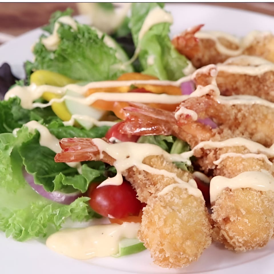 Crispy fried shrimp and scallops with fresh green salad, tomatoes, and creamy dressing.